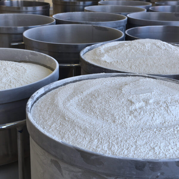 Large metal containers filled with flour in an industrial production area.