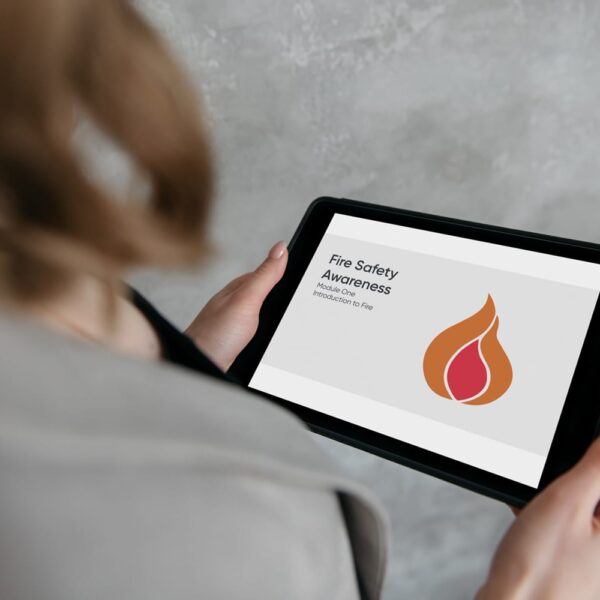A business woman watching an xCenta Fire Safety Awareness eLearning video on a tablet.