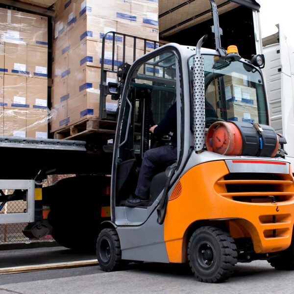 Forklift operator loading pallets onto an HGV trailer.