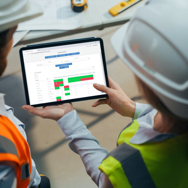 Two workers viewing the xCenta Training Matrix on a tablet